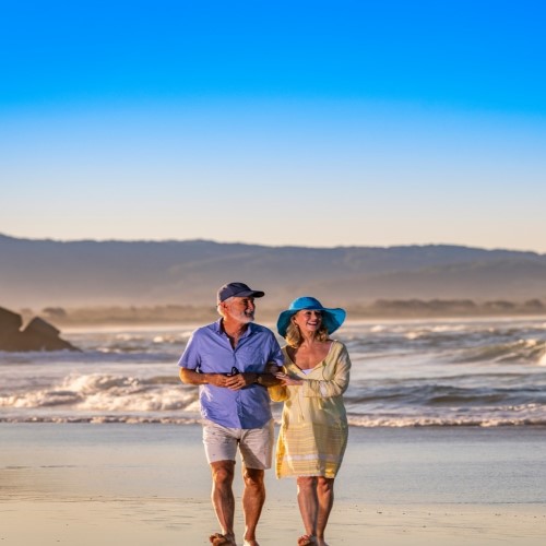 Senior Couple Walking at The Beach